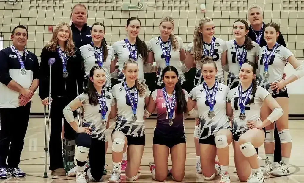 Youth girls volleyball team with coaches after winning a championship Youth girls volleyball team with coaches after winning a championship
